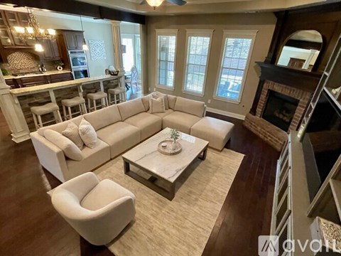 A living room with a white sofa and a coffee table.