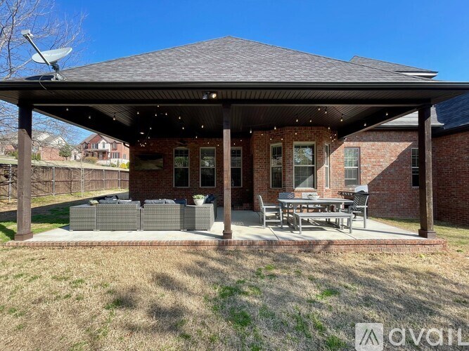 A covered patio area with a table and chairs.
