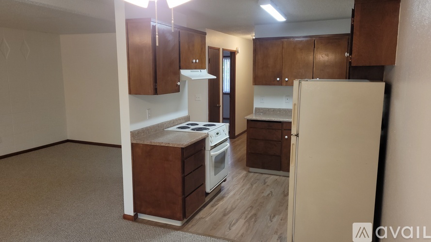 A kitchen with a white refrigerator, white stove, and white oven.