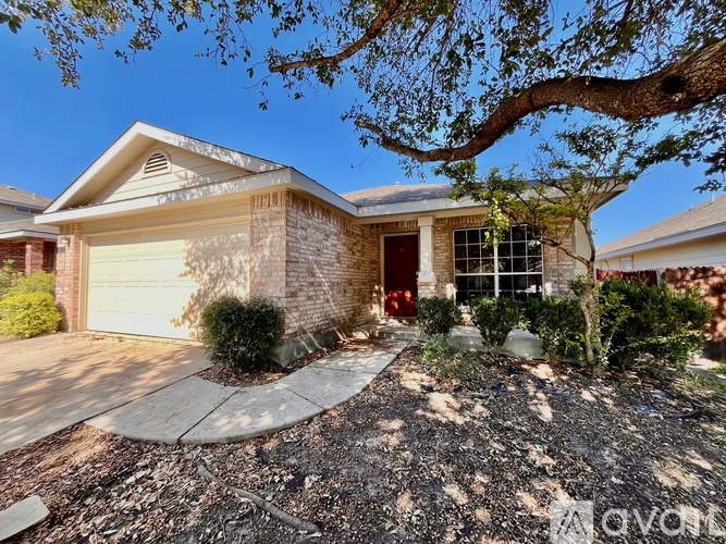 A house with a tree in front of it.