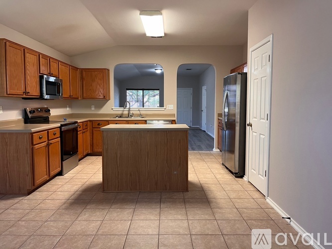 A kitchen with wooden cabinets and a central island.