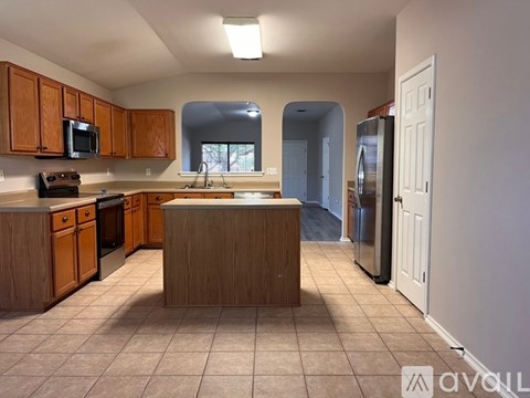 A kitchen with wooden cabinets and a central island.