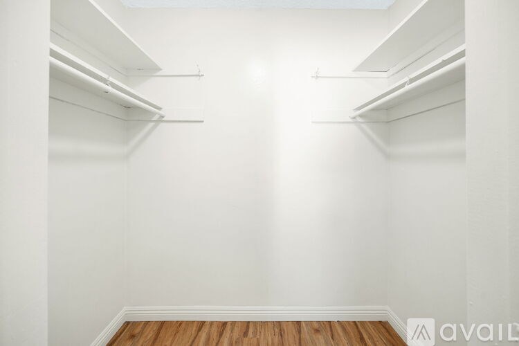 Empty white room with wooden floor and white walls.