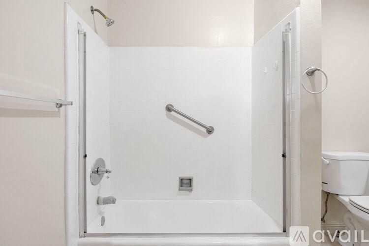 A white bathroom with a walk in shower.