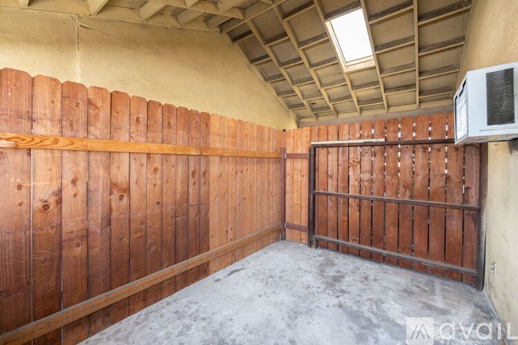 A room with wooden walls and a metal gate.