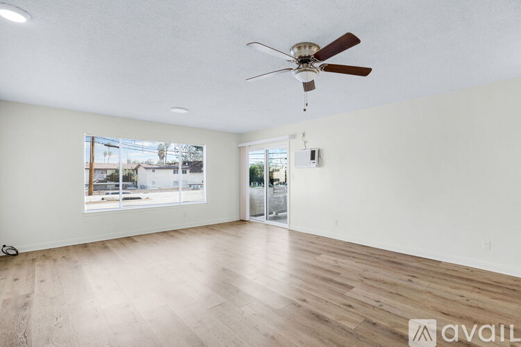 A room with a ceiling fan and wooden flooring is available for rent.