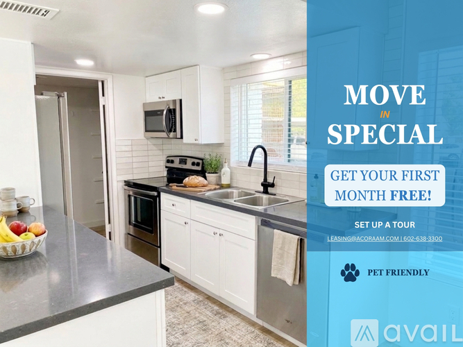A kitchen with a refrigerator, stove, and cabinets is on display with an offer for a first month free.