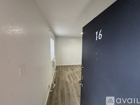 A room with a door numbered 16 and a window.