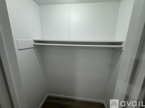 A small, empty room with a shelf and a door.
