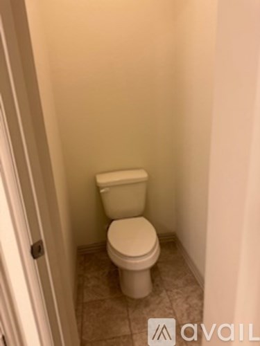A white toilet in a small bathroom.