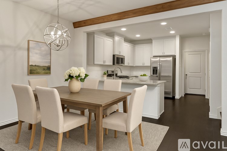 A modern dining room with a wooden table and chairs.