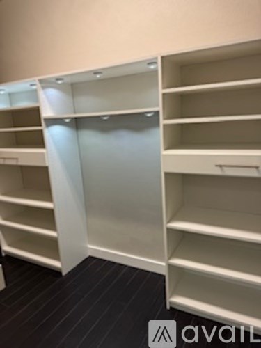 A row of white shelves in a room.