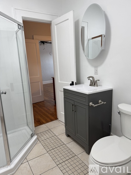 A bathroom with a toilet, sink, and shower.