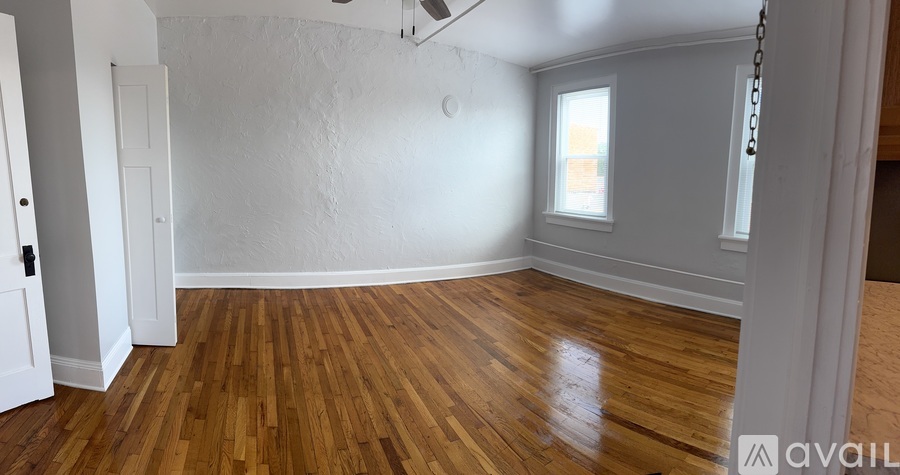A room with wooden floors and a window.