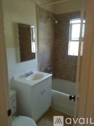 A bathroom with a toilet, sink, and tub.