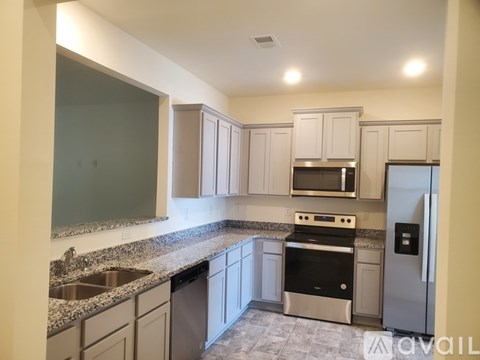 A kitchen with granite countertops and stainless steel appliances.