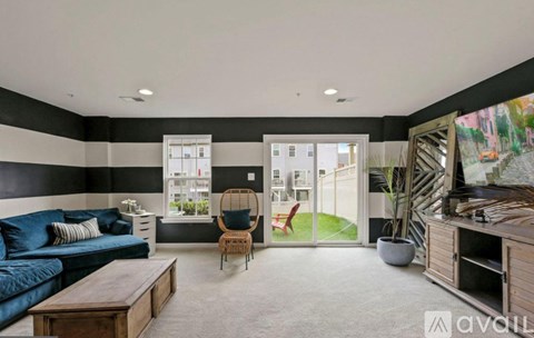 A living room with a blue couch and a wooden coffee table.