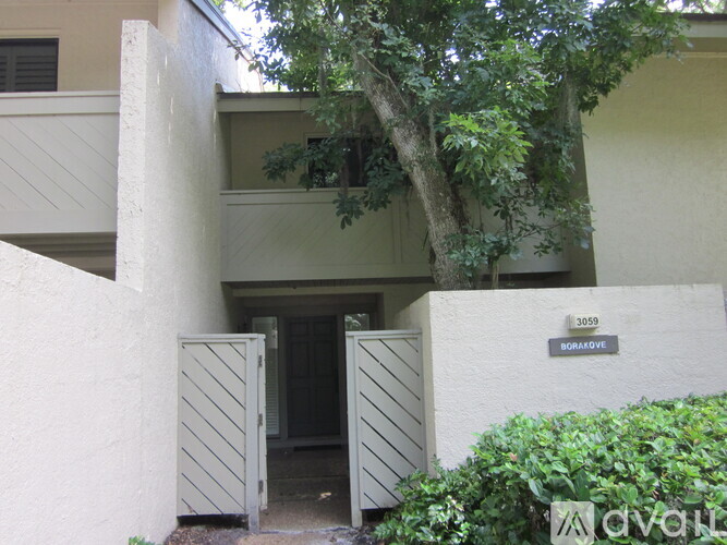 A white building with a tree in front and a sign that says "BORAJOVE".
