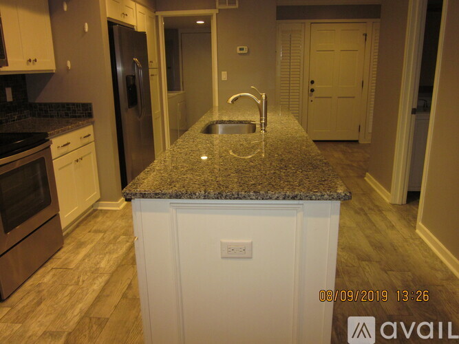 A kitchen with granite countertops and stainless steel appliances.