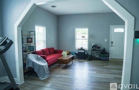 A living room with a red couch and a coffee table.