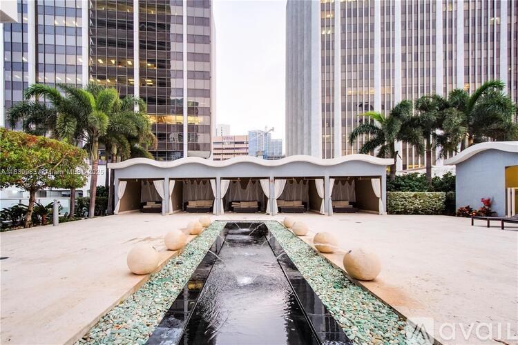 A modern building with a pool in the foreground.