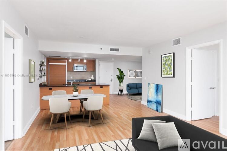 A modern kitchen with a dining table and chairs.