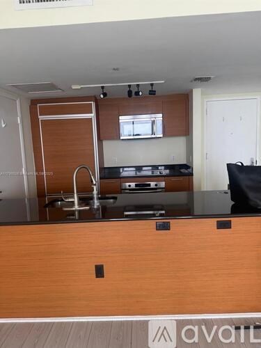 A kitchen with a wooden counter top and a sink.