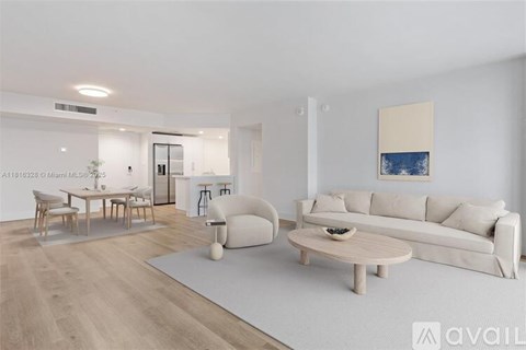 A modern living room with a white sofa, wooden coffee table, and a painting on the wall.