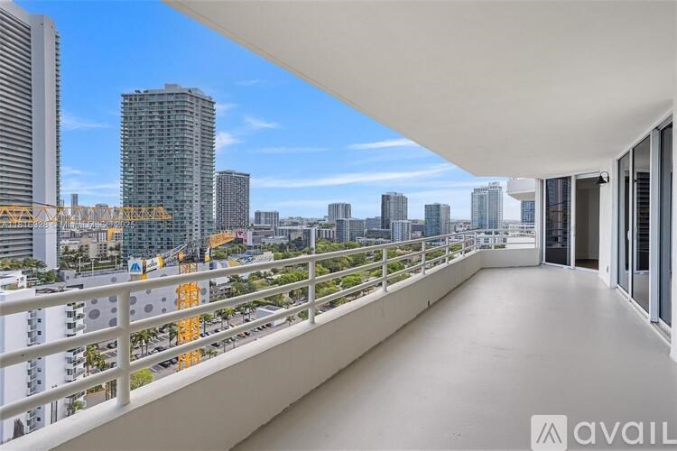 A balcony with a view of a city skyline.