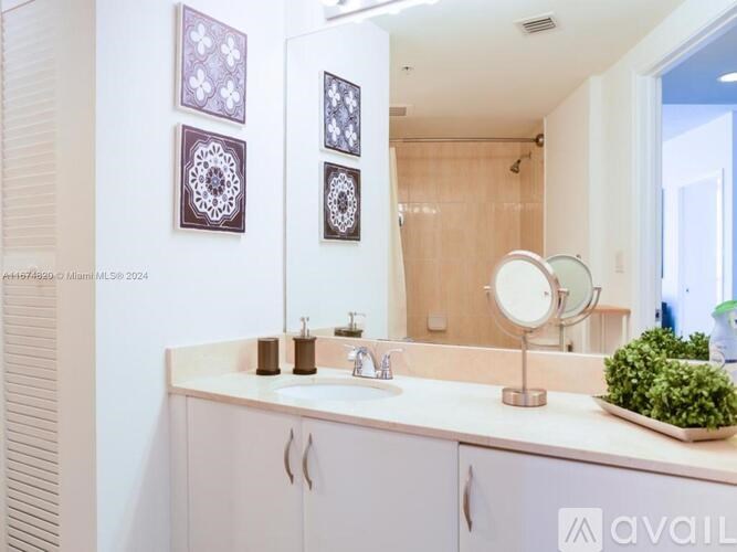 A bathroom with a white counter and a mirror.