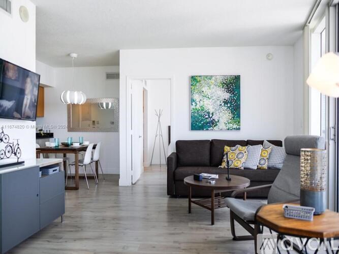 A living room with a grey couch and a wooden coffee table.