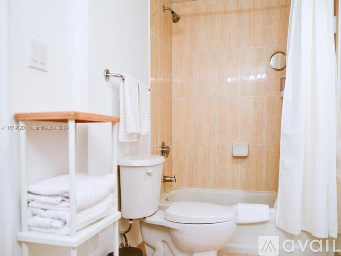 A white toilet and sink in a bathroom.