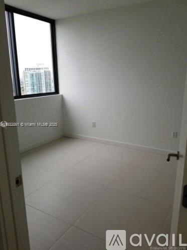 A white room with a window and a door.