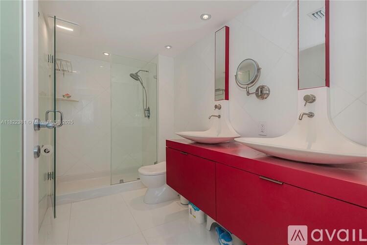 A bathroom with red drawers and a white toilet.