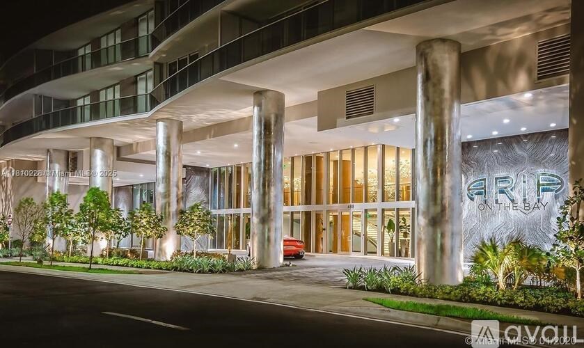 A modern building with a glass facade and a large sign that reads "ARP".