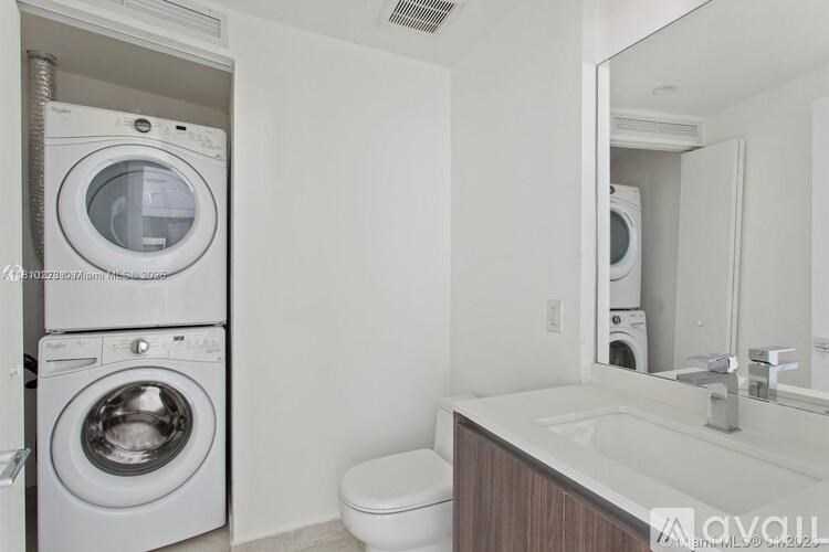 A white washing machine and dryer in a laundry room.