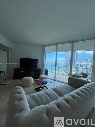 A living room with a large couch and a television.