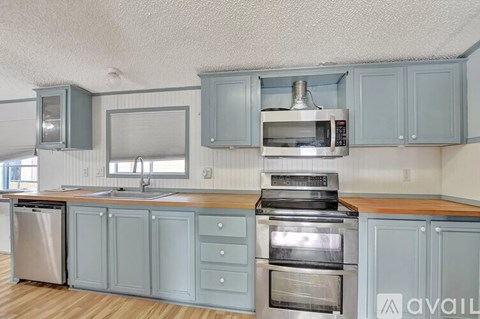 A kitchen with a sink, stove, and oven.