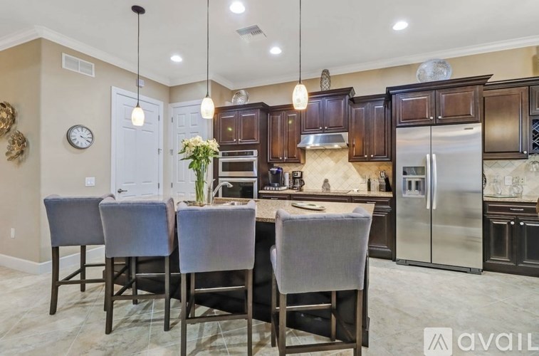 A kitchen with a dining table and chairs.