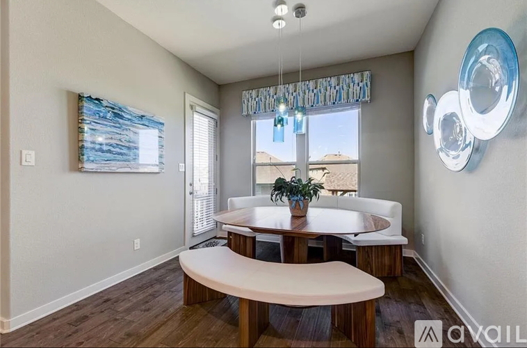 A modern dining room with a wooden table and bench seating.