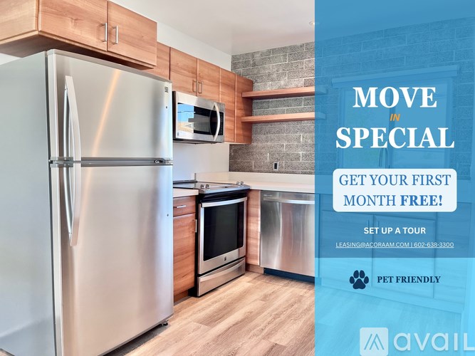 A kitchen with a refrigerator, microwave, and oven is on display for a move-in special.