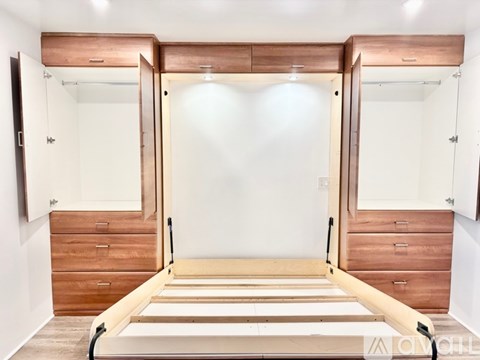 A bedroom with a bed, dresser, and mirror.