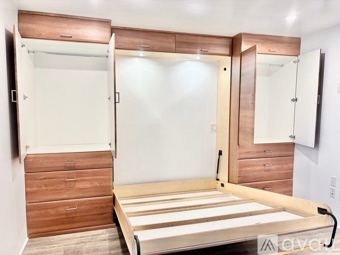 A bedroom with a bed, dresser, and wardrobe.