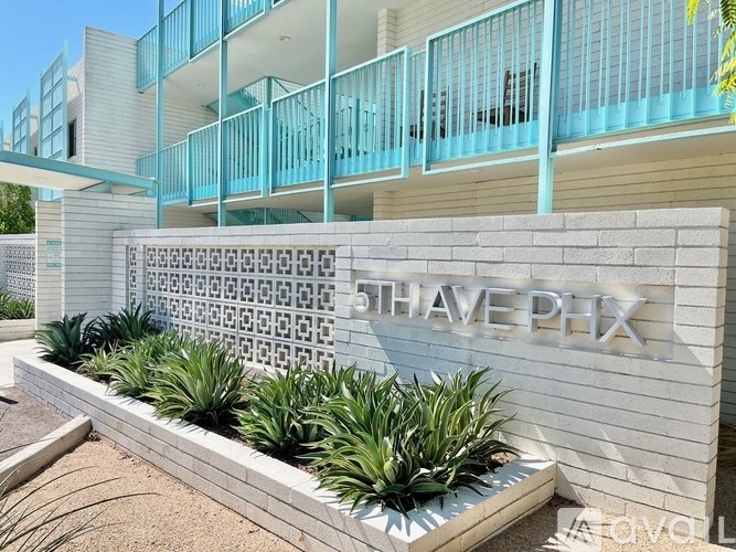 A modern building with the name "THAVE PHX" on a wall.