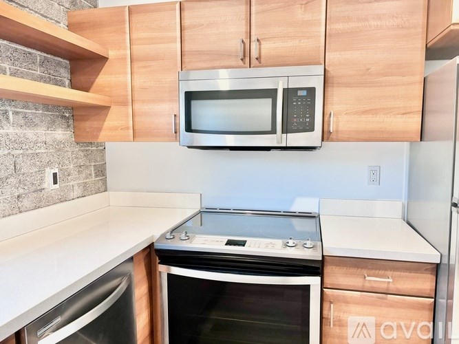 A kitchen with a stove top oven and a microwave above it.