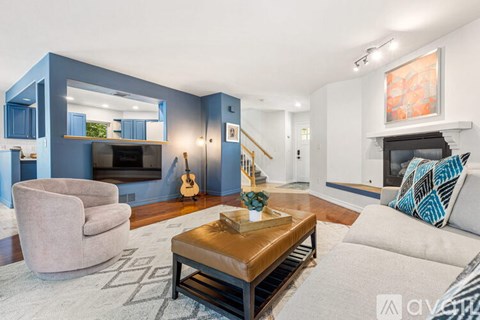 A living room with a brown coffee table and a white couch.