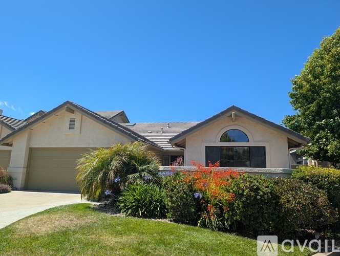 A house with a garage and a driveway is for sale.