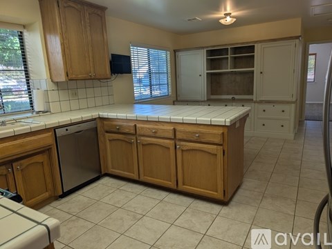 A kitchen with wooden cabinets and a white countertop.