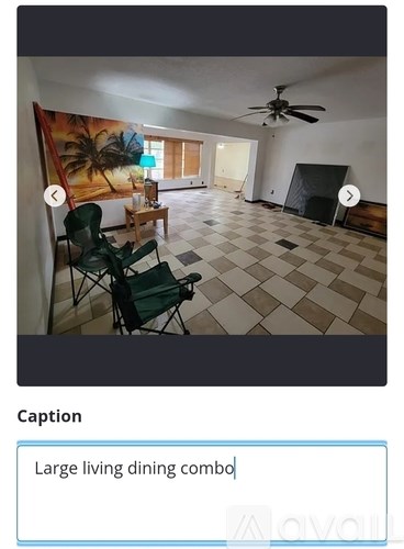 A living room with a dining table and chairs.