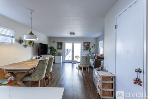 A living room with a dining table and chairs.